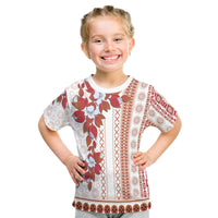 White tapa-style T-shirt with red floral panels and geometric vertical bands, short sleeves
