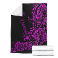 Black and purple Hawaiian blanket with ukulele and floral geometric print, plus rolled towels