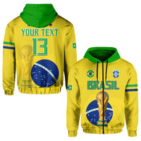 Yellow Brazil football hoodie with green hood, Brasil lettering, and gold trophy on chest.