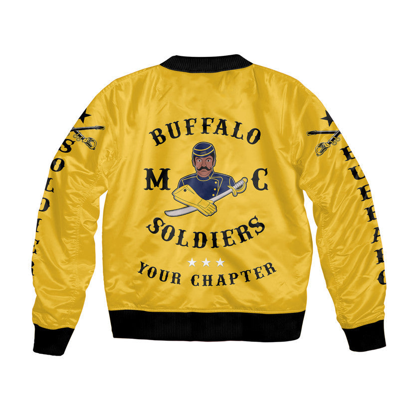 Gold bomber jacket back graphic with motorcycle club emblem text; black ribbed hem.