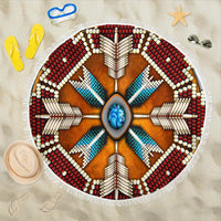 Blue beach blanket with circular native-inspired mandala design, fringe edge and turquoise center