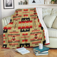 Light brown Native-style blanket with red, black, and tan geometric pattern
