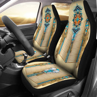 Turquoise tribal breastplate seat covers with beaded tassels on cream upholstery
