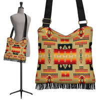 Light brown crossbody bag with colorful native tribe pattern and black fringe hem