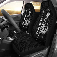 Black front car seat covers installed: Polynesian warrior helmet graphic, tribal motifs