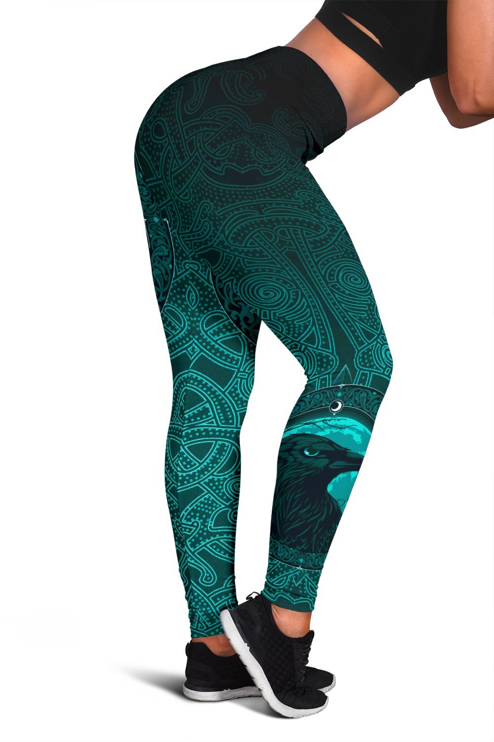 Black-and-teal leggings, close-up side panel with raven eye and swirling rune designs