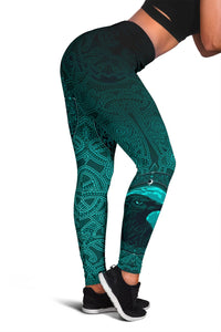 Black-and-teal leggings, close-up side panel with raven eye and swirling rune designs