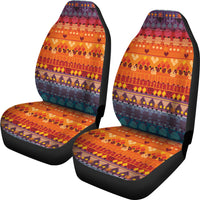 Pair of colorful tribal car seat covers; orange cushions with purple headrest panels