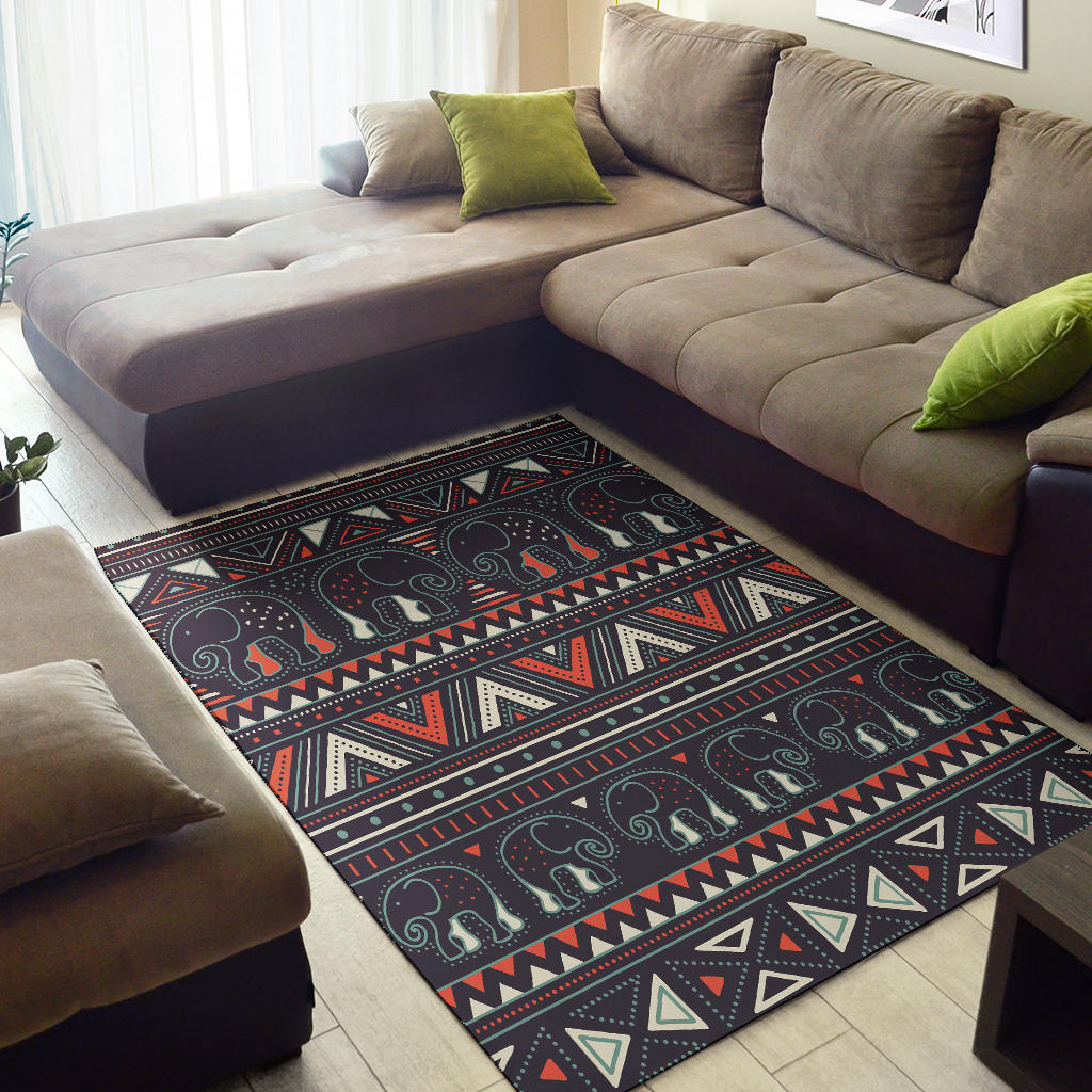Tribal elephant area rug with geometric borders, dark base, red and cream accents