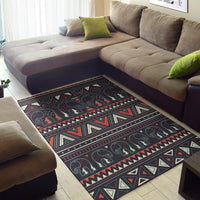 Tribal elephant area rug with geometric borders, dark base, red and cream accents