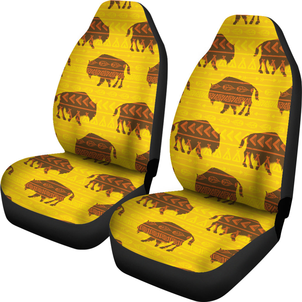Pair of yellow front seat covers with black edges, featuring bison and tribal icons
