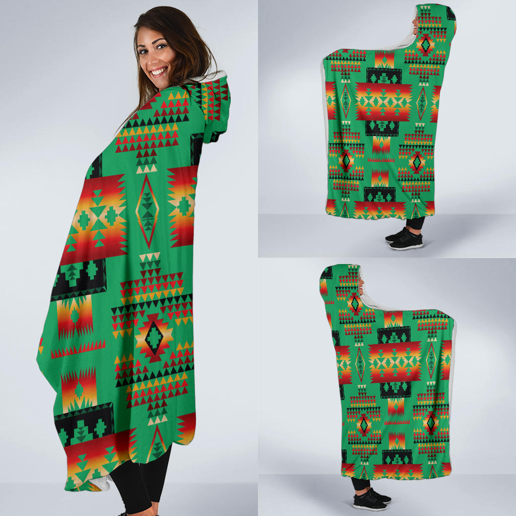 Multicolor Native American patterned hooded blanket worn over leggings, corner drape
