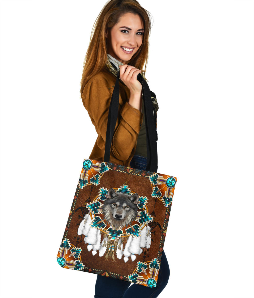 Brown tote with frontal wolf face print, turquoise-and-gold geometric pattern, side view