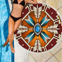 Native mandala beach blanket with turquoise-blue rays, brown center and red bead pattern, fringe