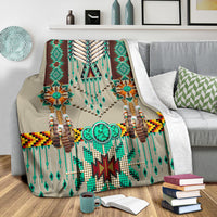 Breastplate blanket draped on couch featuring teal, brown, and cream bead-pattern details