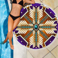 Round beach blanket draped on the poolside: purple mandala with turquoise accents and fringe