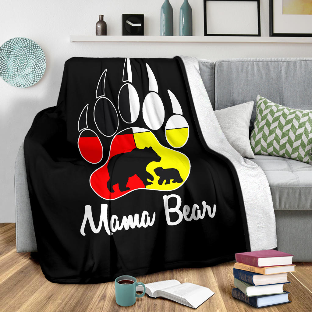 Black blanket spread on bed with bear paw emblem and 'Mama Bear' printed text