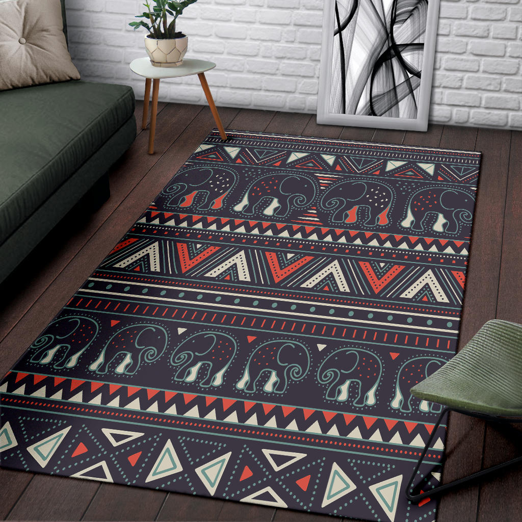 Close-up corner of dark tribal elephant rug with dotted swirls and geometric trim