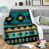 Folded teal Aztec blanket with black and tan starburst motifs