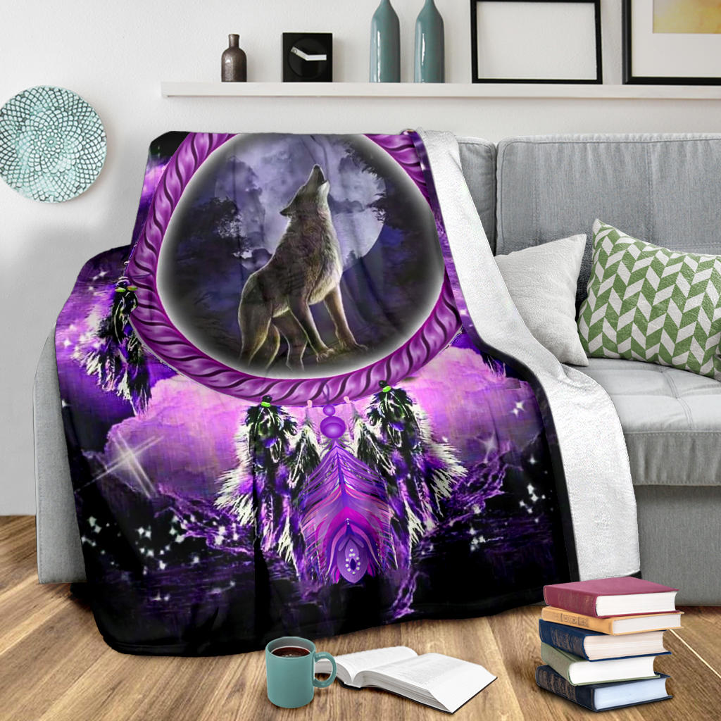 Howling wolf dream catcher blanket on couch with large purple moon wolf design