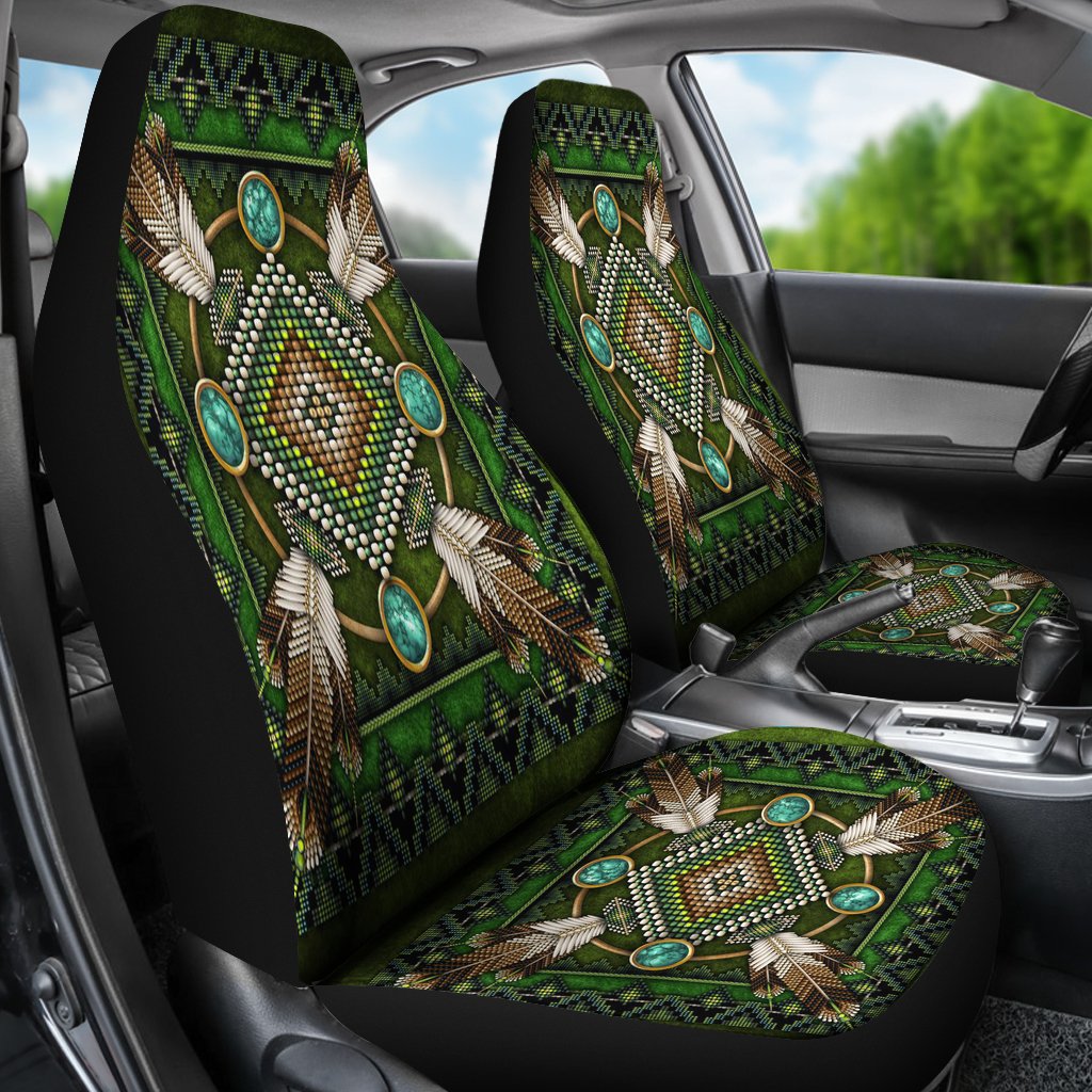 Two green seat covers in car, native mandala design with turquoise ovals on black backing
