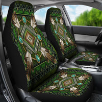 Two green seat covers in car, native mandala design with turquoise ovals on black backing