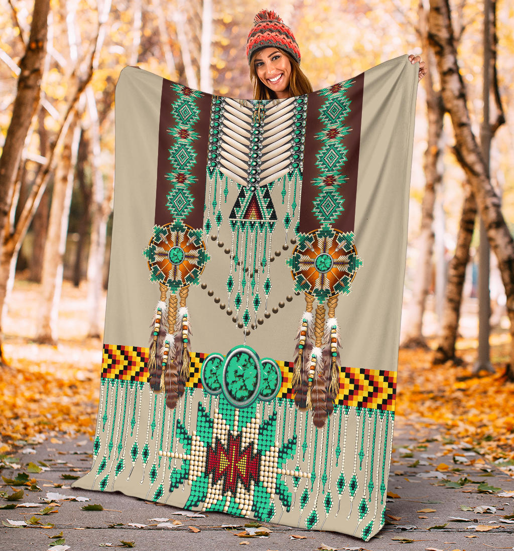 Breastplate blanket held outdoors; teal beadwork, ornate center motif, and striped border