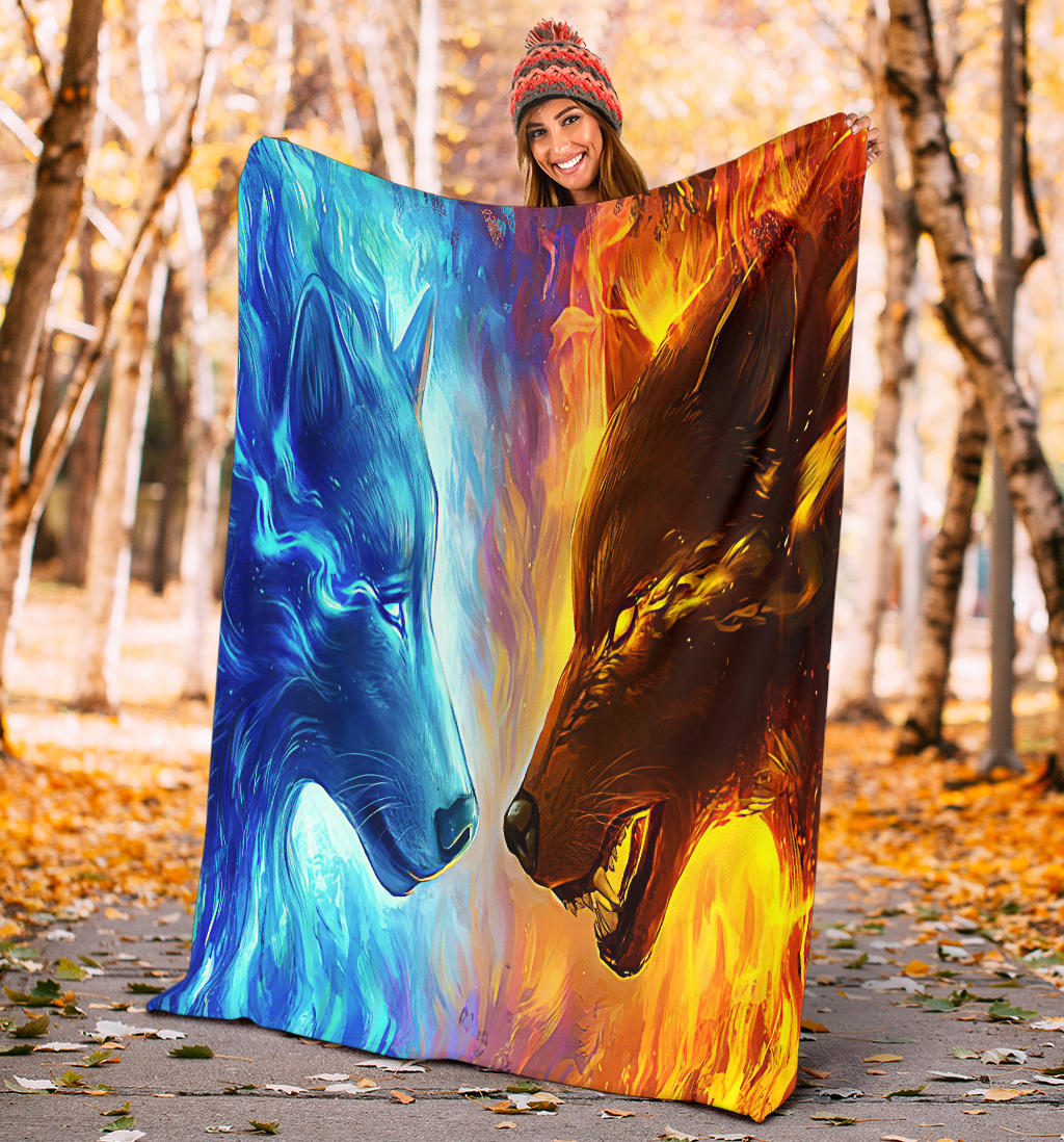 Ice Fire Wolf blanket outdoors, blue-and-orange wolf face design held up