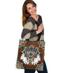 Brown tote bag with wolf face centerpiece and turquoise medallion corners, front view