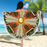 Native mandala beach blanket shown flat, green/brown radial pattern with white fringe