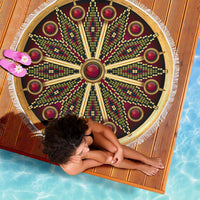 Round mandala beach blanket top view, dark maroon pattern with gold rays and red rings