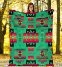 Light green tribal-inspired geometric blanket with bright red and teal accents