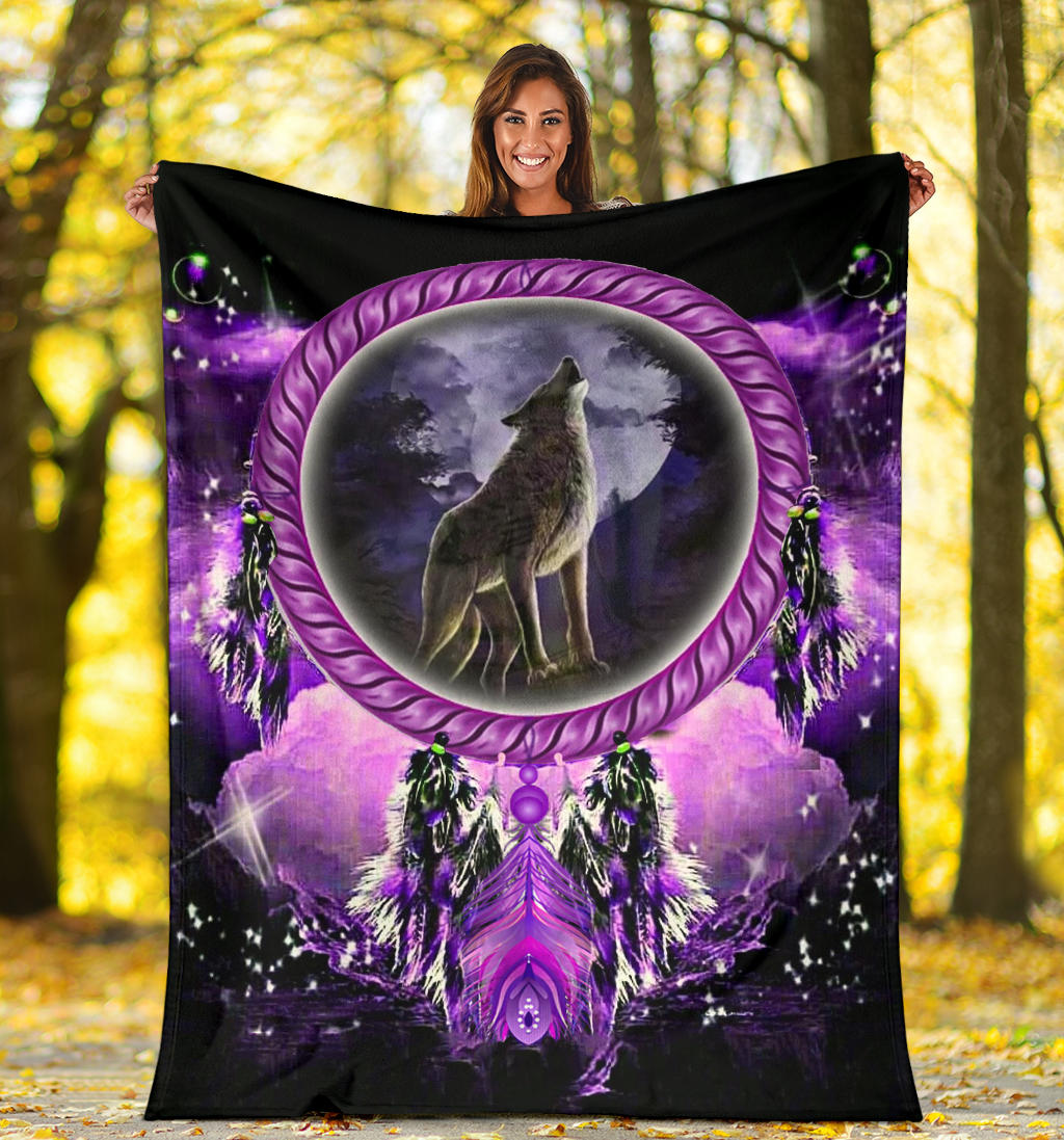 Dream catcher blanket outdoors showing wolf in purple oval with feathered dreamcatchers