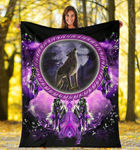 Dream catcher blanket outdoors showing wolf in purple oval with feathered dreamcatchers