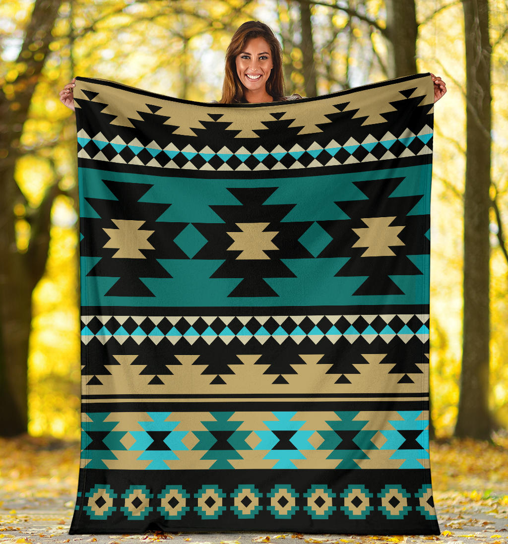 Teal Aztec blanket with large black star shapes, tan centers, and blue diamond row