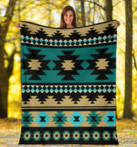 Teal Aztec blanket with large black star shapes, tan centers, and blue diamond row