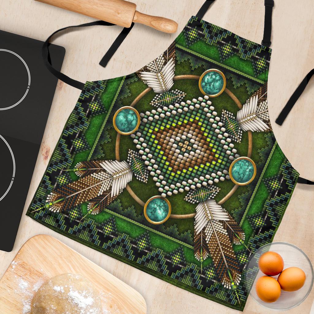 Green mandala apron close-up: beaded heart motif with turquoise circles and feather trim