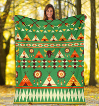 Green patterned blanket spread out, with tents, bison, and dreamcatcher circles