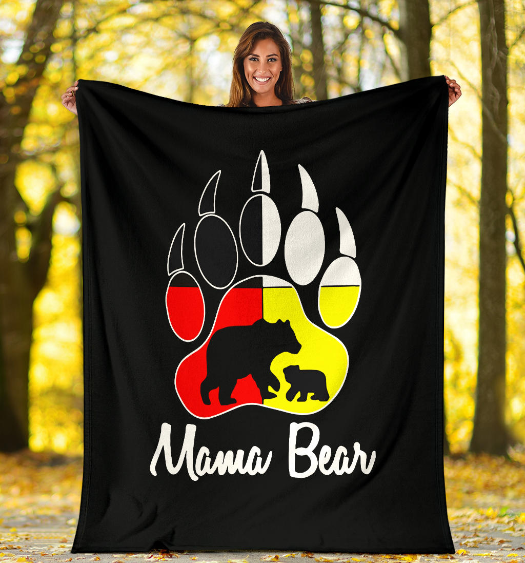 Black fleece blanket held outdoors with bear paw graphic and 'Mama Bear' text