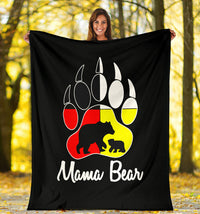 Black fleece blanket held outdoors with bear paw graphic and 'Mama Bear' text