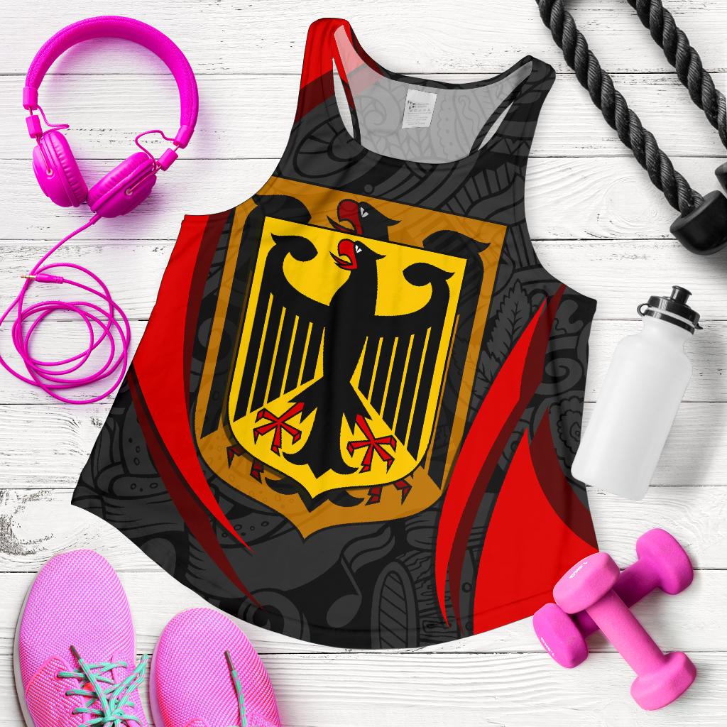 Black racerback tank laid flat with bold yellow crest shield and red side panels