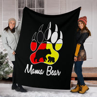 Black blanket stretched indoors showing colorful bear paw logo and 'Mama Bear'