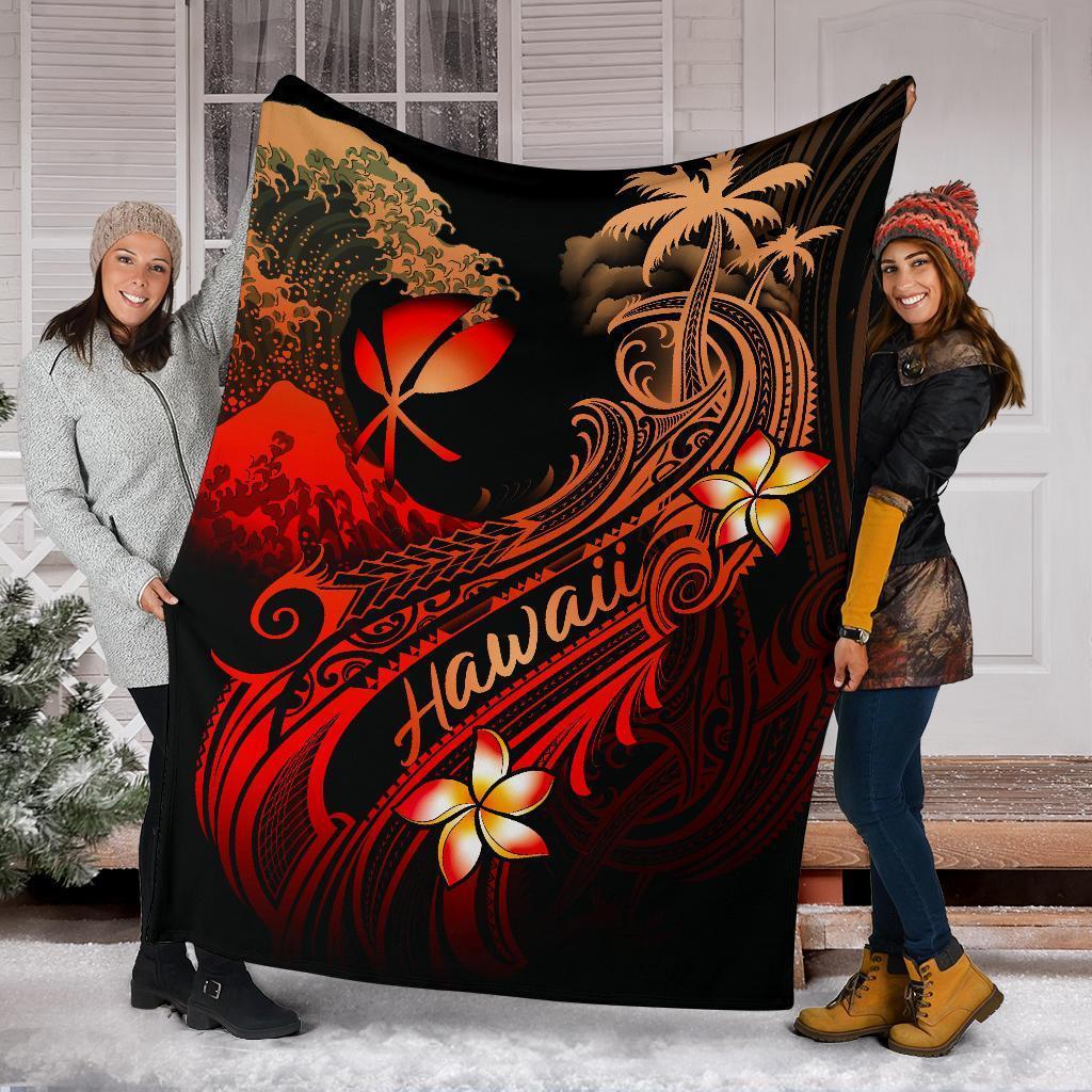 Black Hawaii blanket spread between two people; red plumeria flowers, palms, and wave swirls