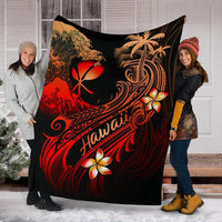 Black Hawaii blanket spread between two people; red plumeria flowers, palms, and wave swirls