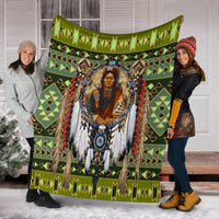 Green multicolor chief blanket spread out indoors with fringe and tribal motifs