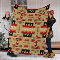Light brown Native-style blanket held up, red and black tribal squares and arrow shapes