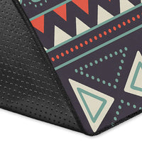 Edge close-up of dark tribal elephant rug with stitched border and geometric triangle details