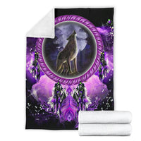 Dream catcher blanket folded with white backing, purple moon wolf and feather motifs