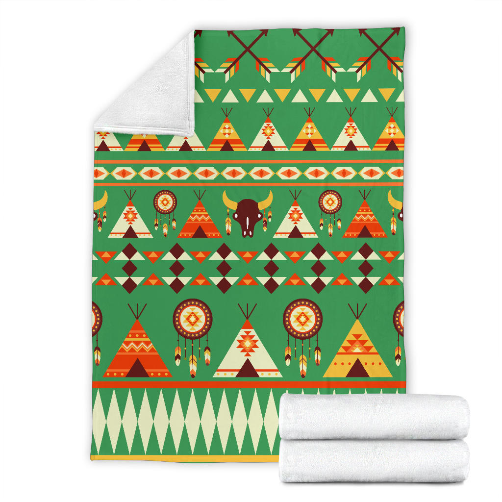 Green patterned blanket with tents, bison, dreamcatcher circles; folded with white backing