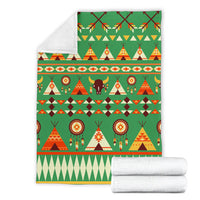 Green patterned blanket with tents, bison, dreamcatcher circles; folded with white backing